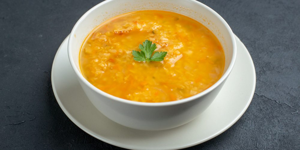 front-view-delicious-soup-inside-white-plate-dark-surface