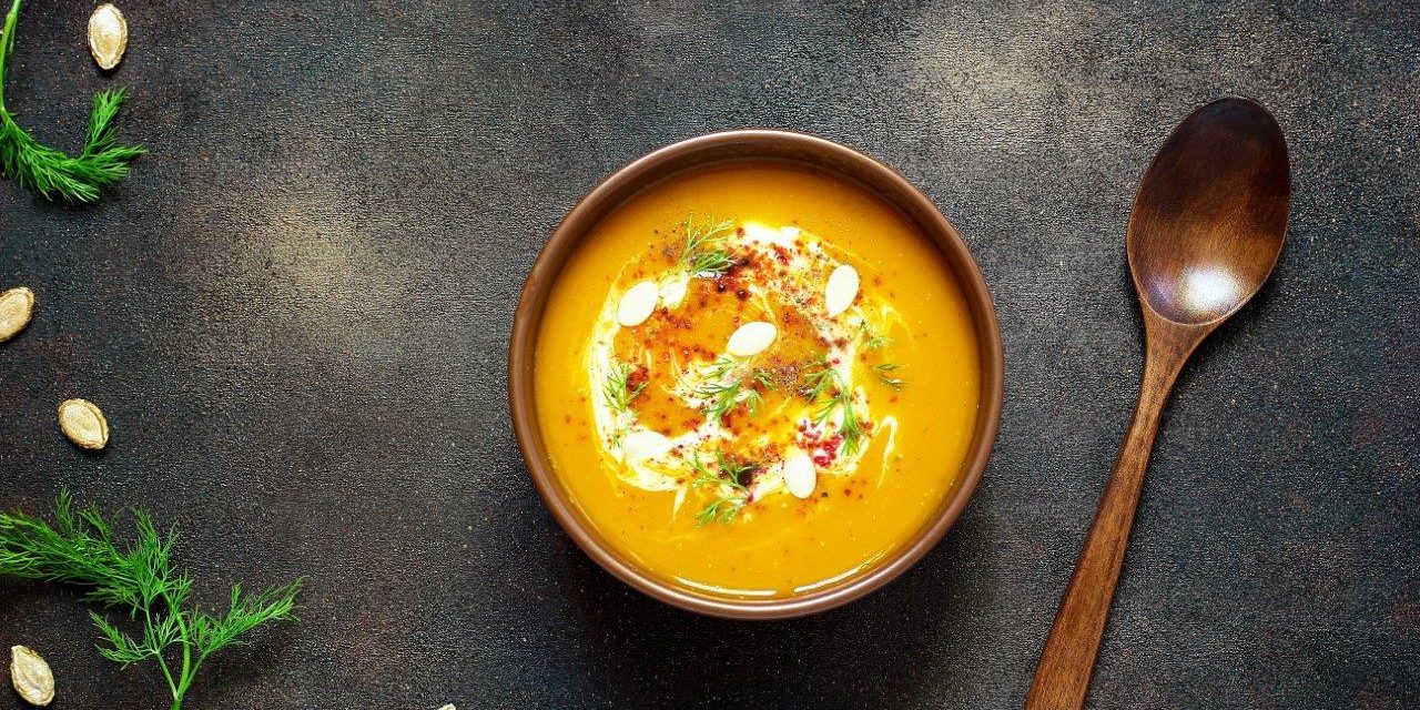 roasted-pumpkin-carrot-soup-with-cream-seeds-fresh-green-ceramic-bowl-top-view