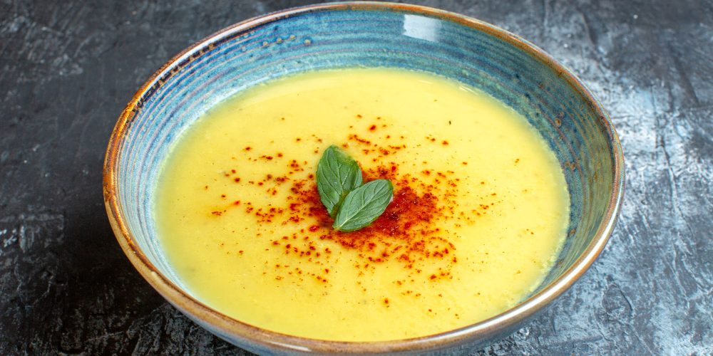 view-blue-pot-with-tasty-soup-served-with-mint-blue-table