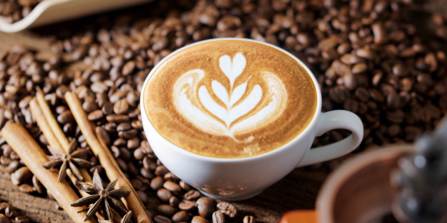 white-coffee-cup-roasted-coffee-beans-around